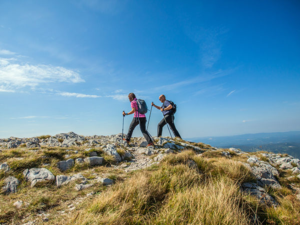 Couple Hiking Nanos Plateau Slovenia Against Blue Sky TN